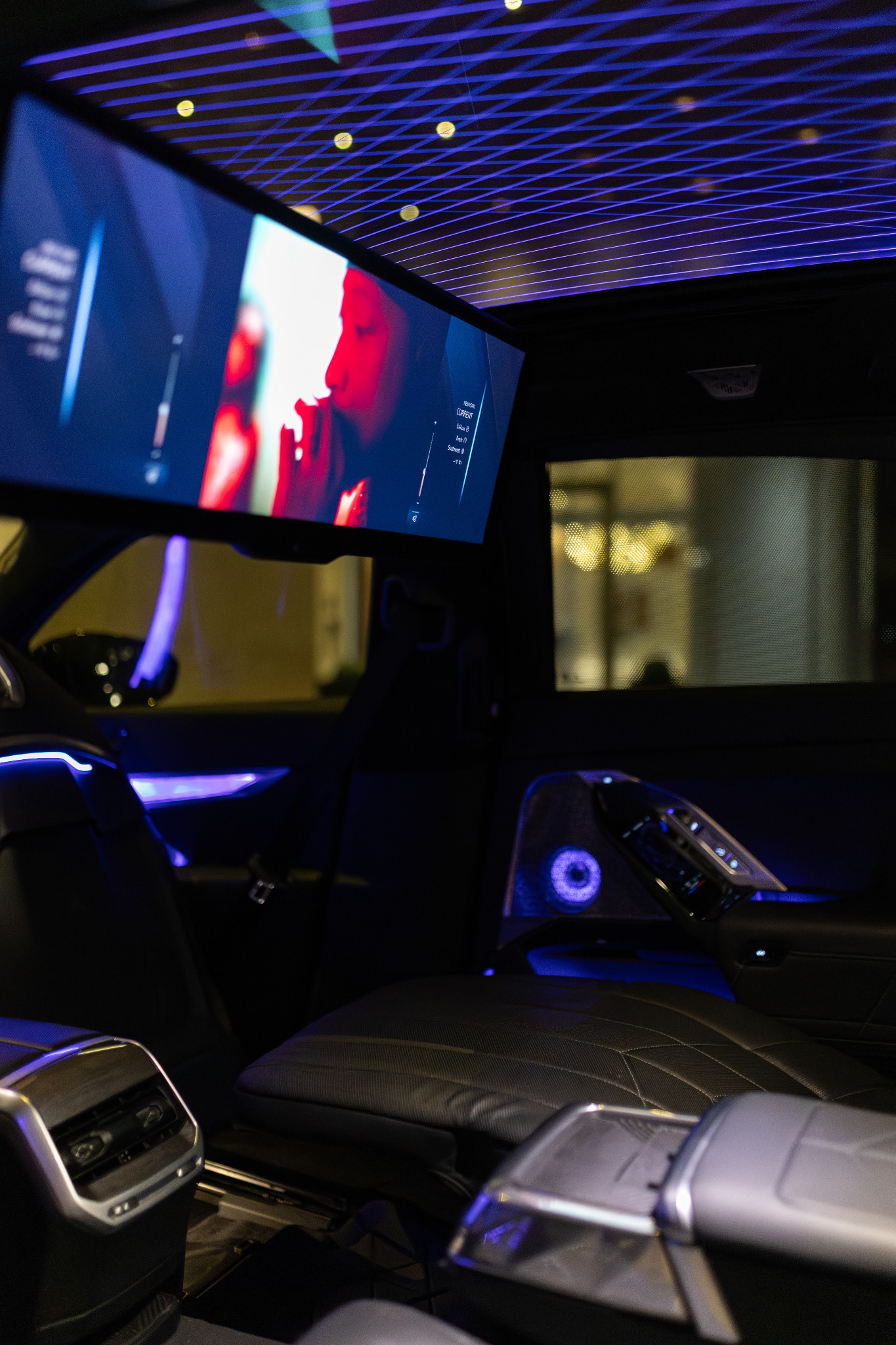 BMW rear cabin with theater screen and ambient lighting